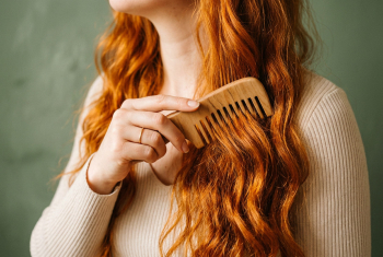 close up shot of womans hand combing through hair