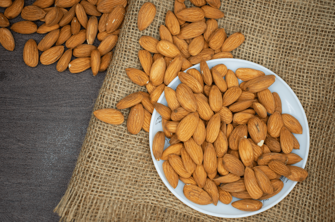 a bowl full of almonds spilling over