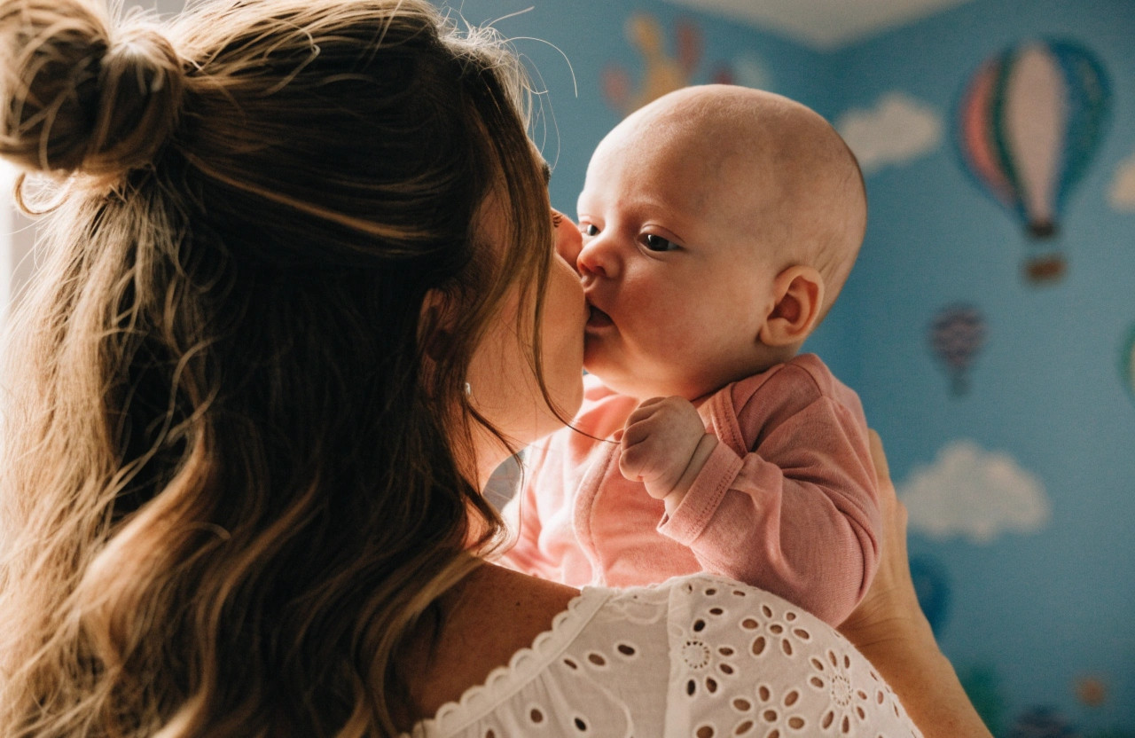 close up shot of mother kissing a baby