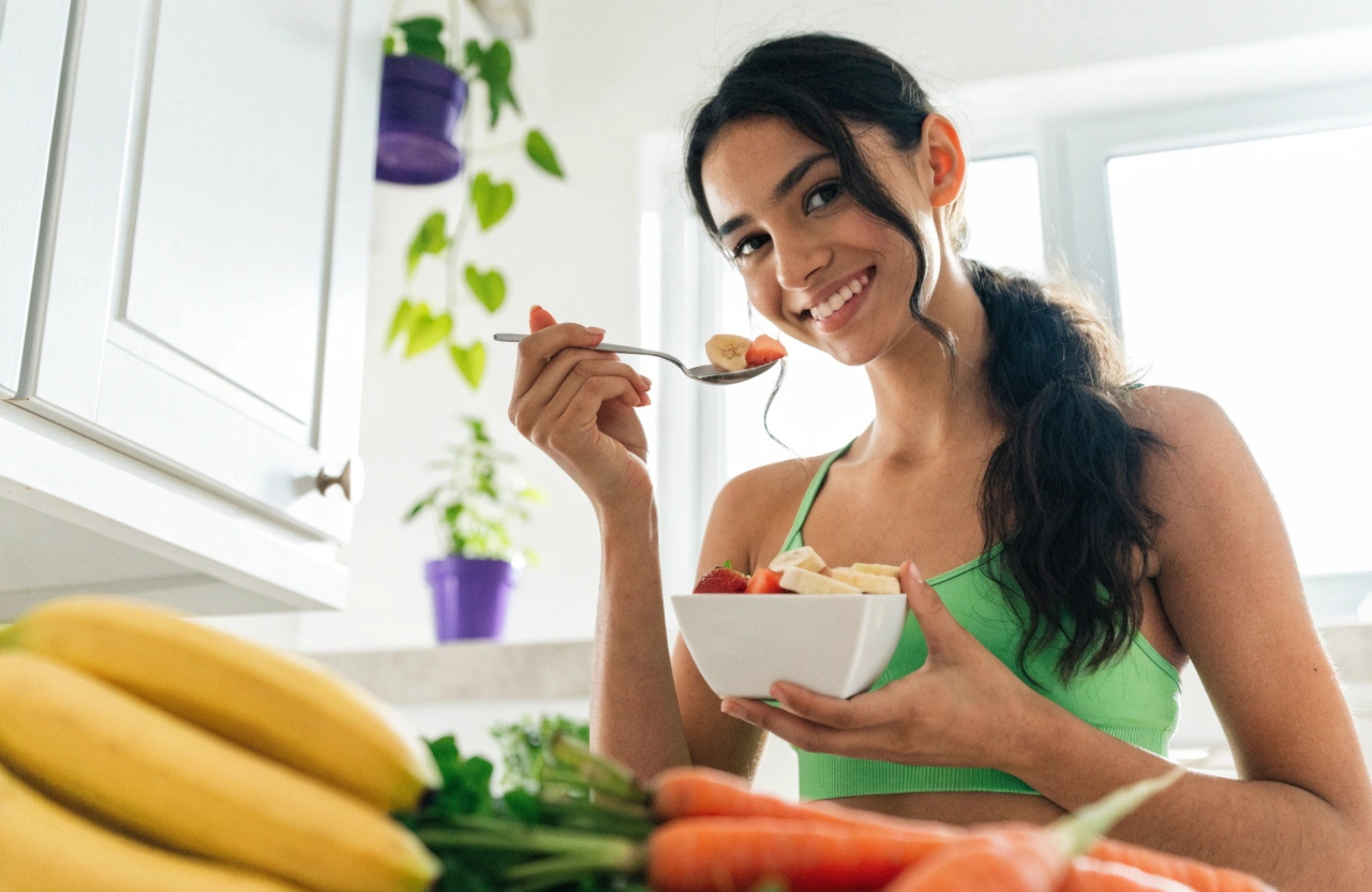 smiling young woman with a bowl of fruit