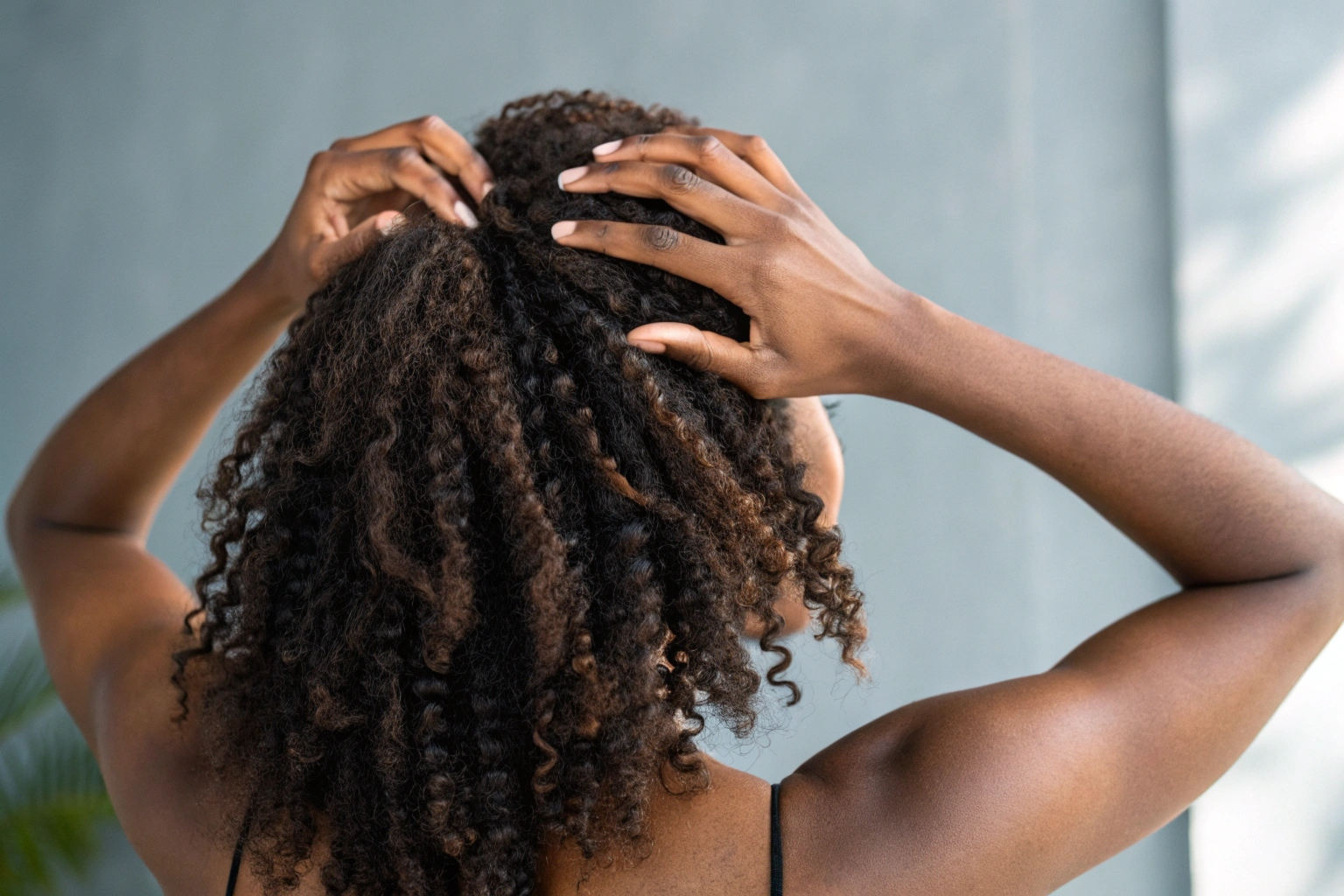 woman examining her scalp