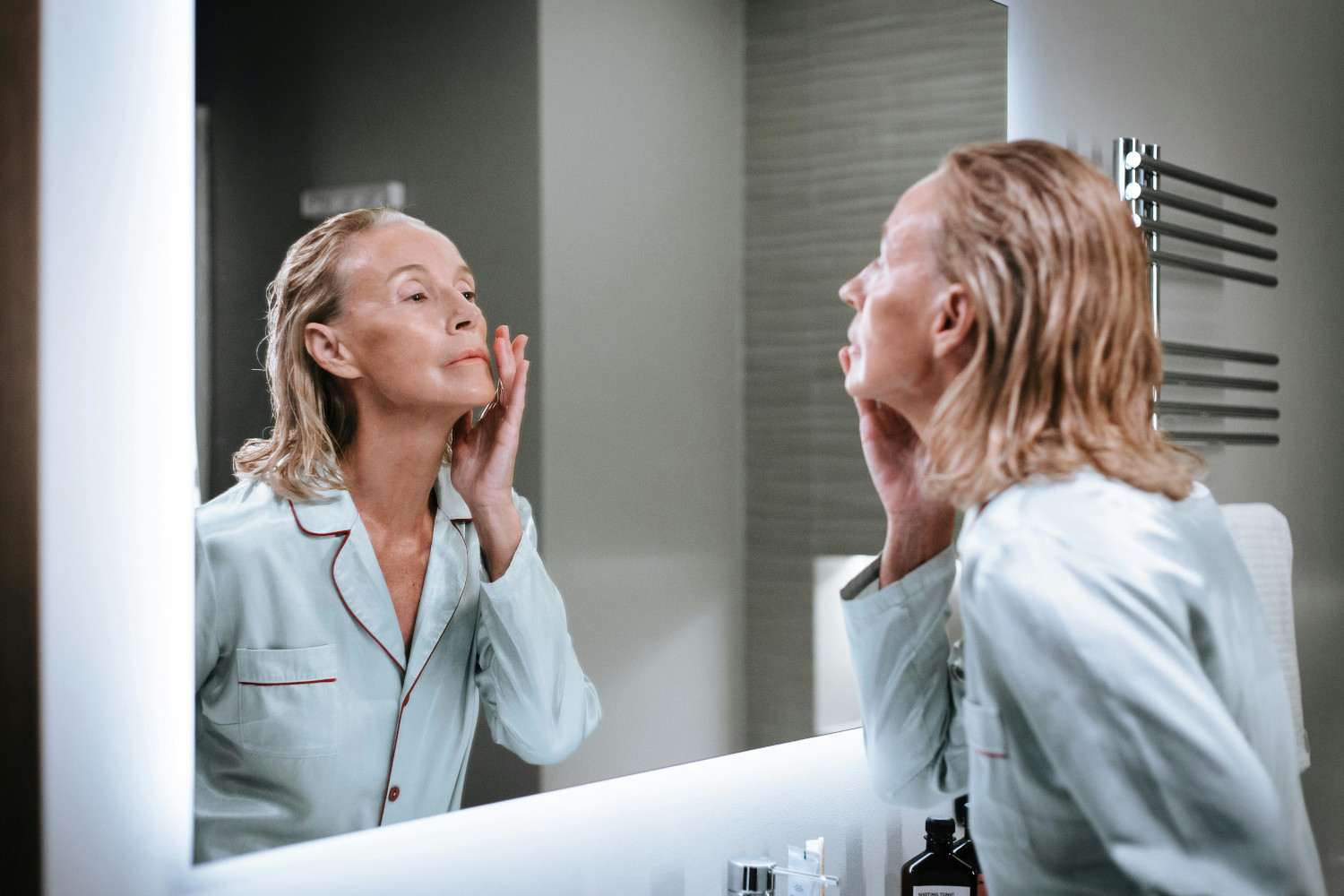 woman looking into mirror